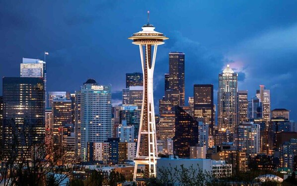 A city skyline with a prominent tower and various buildings.