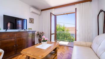 Apartment (Three-Bedroom Apartment with Balcony ) | Living room | 32-inch flat-screen TV with satellite channels