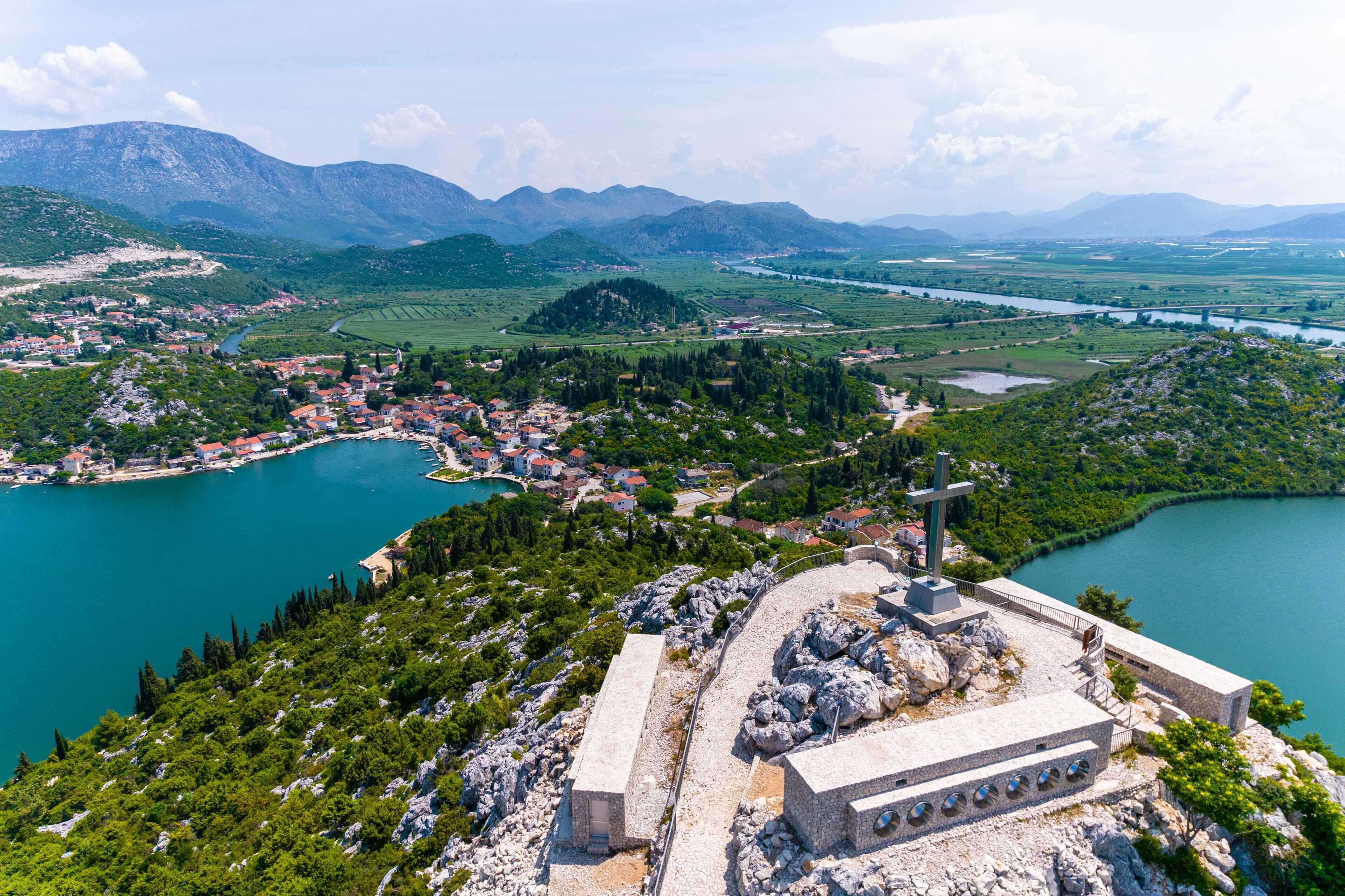 A coastal town with a prominent church and rocky terrain.