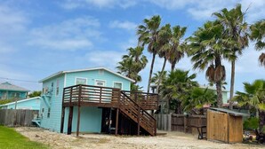 A turquoise two-story house with a wooden deck and a small shed. - Private Pool, Golf Cart Access, Boat Parking (Port Aransas)