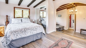 A bedroom with a large bed, wooden beams, a mirror, and a view to the dining area. - Massachusetts Abode w/ Deck & Grill: Near Beaches! (Gloucester)