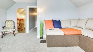 A cozy living room with a sofa, a chair, and a dining area visible through an archway. - Pet-friendly Cincinnati Apt: 5 Mi to Downtown! (Cincinnati)