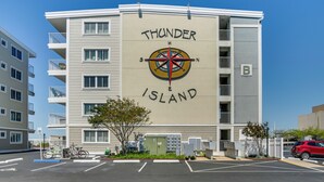 A multi-story building with a compass mural on the side, labeled "Thunder Island."