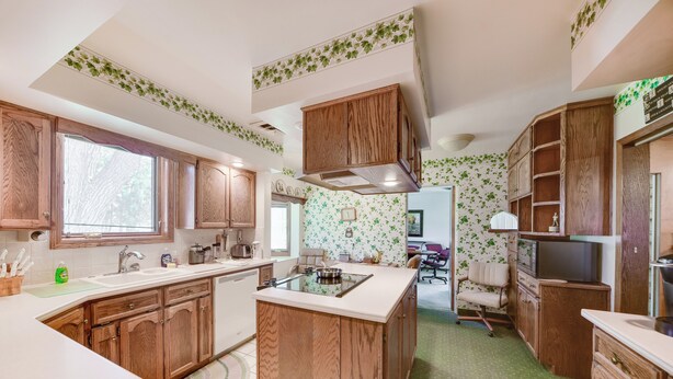 A kitchen with wooden cabinets, a central island, and a window. - Chappell Vacation Rental w/ Patio + Fire Pit! (Chappell)