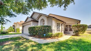 A residential house with a front yard, a driveway, and a mailbox.