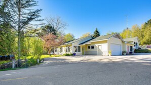 A two-story house with a garage, a covered porch, and a driveway. - Relax Fireside! Frankfort Apt Near Dtwn & Beaches (Frankfort)