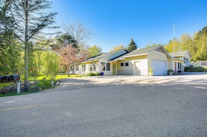 A two-story house with a garage, a covered porch, and a driveway.