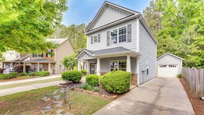 A two-story residential house with a front porch, a garage, and a well-maintained lawn with stone pathways. - Canton Home w/ Fenced Yard: 6 Mi to Lake Allatoona (Canton)