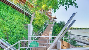 A wooden staircase leading to a building with a 2 rider limit sign.