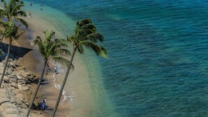 A beach with palm trees and people. - Royal Kahana 1211 2 Bedroom Condo (Lahaina)