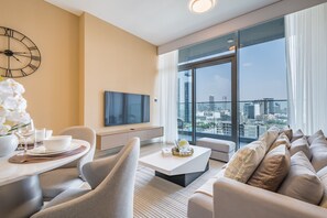 Enjoy a panoramic city view from the large window, relax in the comfortable seating area, and dine at the table for two.