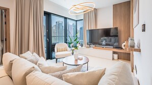 Un salon moderne avec un canapé, une table basse et un téléviseur.