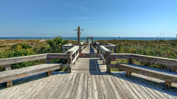 A wooden boardwalk leading to a beach with a clear view of the ocean. - Prime Oceanfront Location: Pool, Balcony & Tennis Court (Wrightsville Beach)