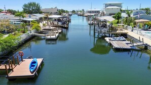 A marina with docks and boats, surrounded by residential buildings and greenery.