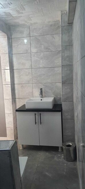 Shower, hair dryer, slippers, towels