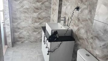 Shower, hair dryer, slippers, towels