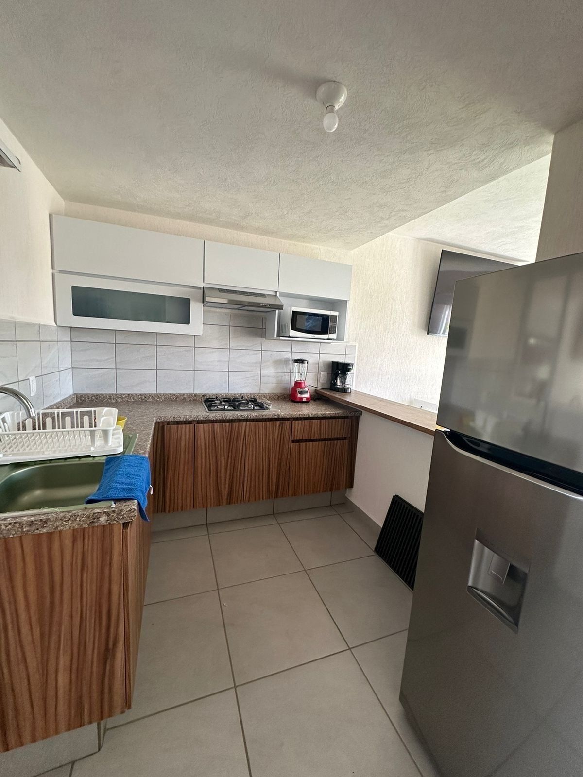 A modern kitchen with a built-in microwave, stove, and refrigerator.
