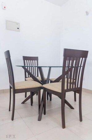 Enjoy meals in this cozy dining area with a round table and comfortable seating for four.