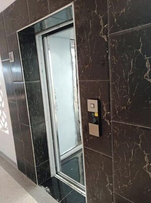 Step into a sleek, modern corridor and access your accommodations via this convenient elevator.