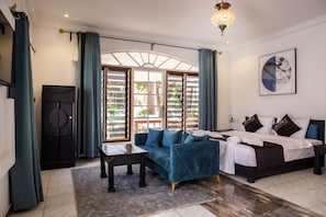 A modern bedroom with a bed, a sofa, a desk, and a wardrobe. - Coconut Residence & Spa (Serrekunda)