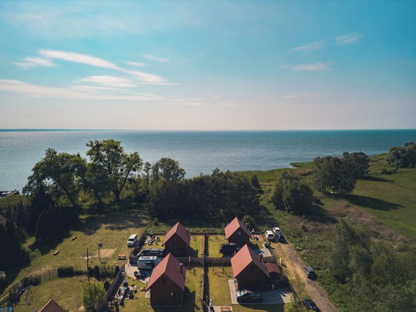 A residential area with two houses, a playground, and a view of the sea.