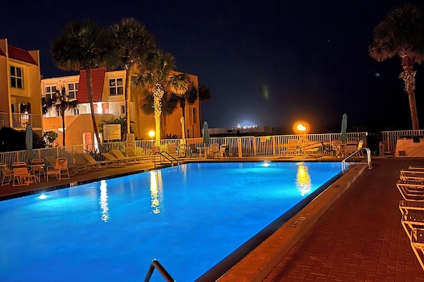 Condo Pool, heated in cooler weather, lit beautifully in the evening time.