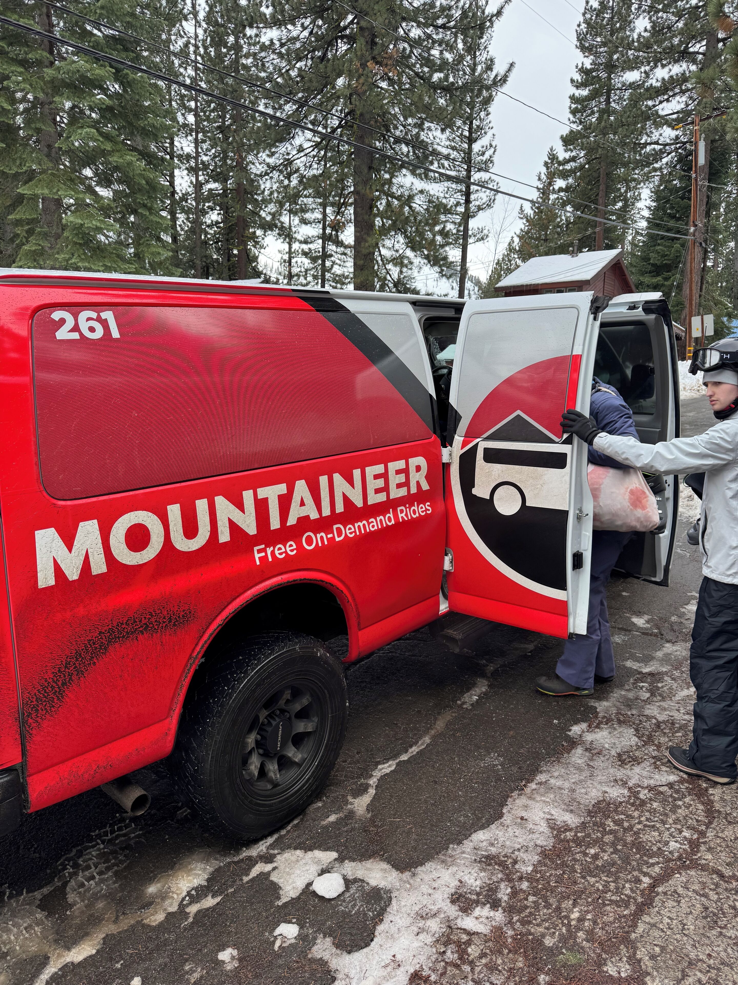 A red van with the number 261 and the text "MOUNTAINER Free On-Demand Rides."