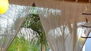 An outdoor dining area with a table set for two, surrounded by white chairs. - Rida Village Ksamil Island (Ksamil)