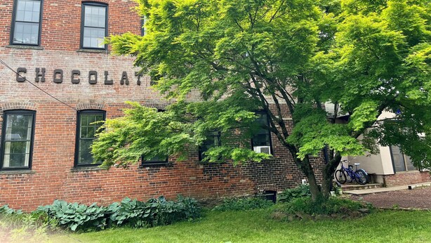 A brick building with the word "CHOCOLAT" on the side. - Spacious, artist-designed apartment in 1890s chocolate factory. DOG FRIENDLY! (Hopewell)