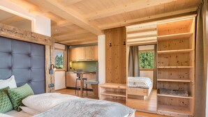 A bedroom with a large bed, a built-in desk, and a wooden wardrobe. - Apartment 'Zirm' with Mountain View, Private Terrace and Wi-Fi (Jenesien)