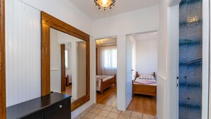 A bedroom with a wooden bed, a dresser, and a mirror. - 2 bedroom beach front apartment in Rtina (Rtina)