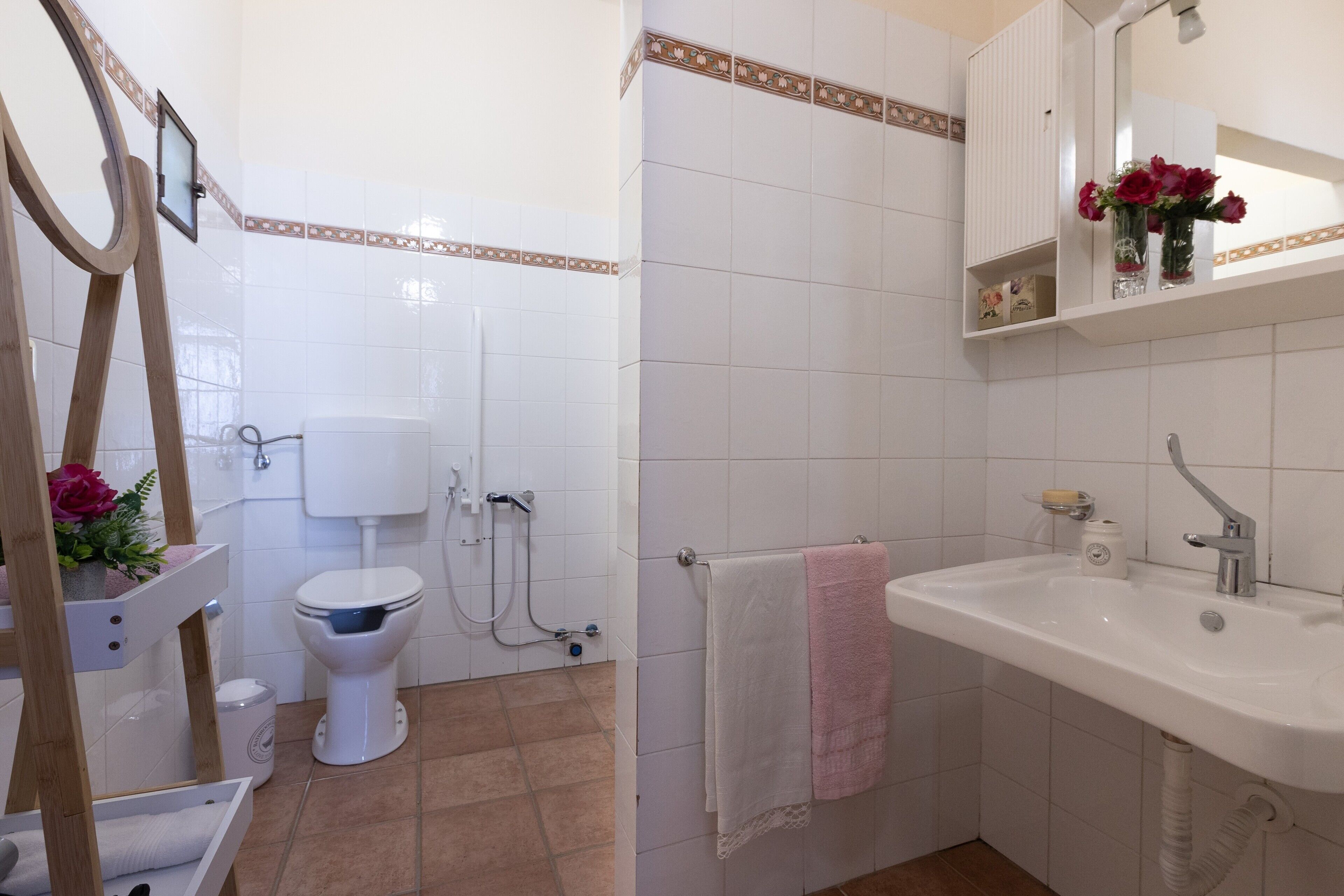 A bathroom with a toilet, sink, and shower.
