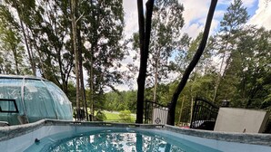 A swimming pool with clear blue water, surrounded by trees and a fence. - Countryside Getaway Sand UniqueDomeB/serene farm retreat (Snow Camp)