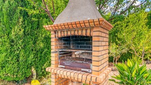 A brick outdoor grill with a chimney, surrounded by greenery. - Villa "Bohemia" with Sea Views, Private Pool, and Wi-Fi (Jávea)