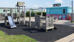 A playground with a slide and climbing structures. - 3 bedroom accommodation in Heysham, near Lancaster (Heysham, near Lancaster)