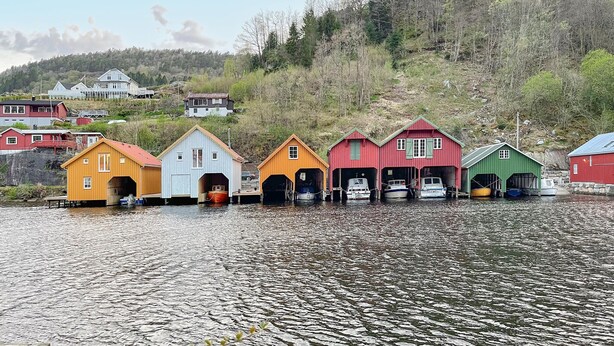 A row of colorful wooden buildings by a lake, likely used for storage or as boathouses. - 2 bedroom beautiful home in Feda (Feda)