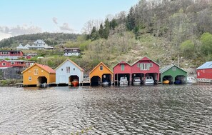 A row of colorful wooden buildings by a lake, likely used for storage or as boathouses. - 2 bedroom beautiful home in Feda (Feda)