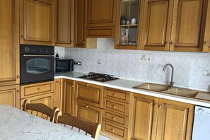 Jääkaappi, uuni, astianpesukone, ruokailupöytä