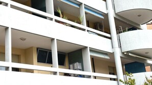 A multi-story building with balconies, windows, and a cylindrical structure. - SE090 - Marzocca, comfortable three-room apartment 150 meters from the sea (Marzocca)