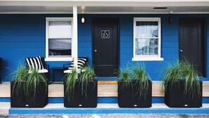 A blue building with a black door marked "No 23". - Seabirds Motel At Kure Beach (Kure Beach)