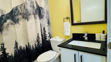 Combined shower/bathtub, towels, soap, shampoo