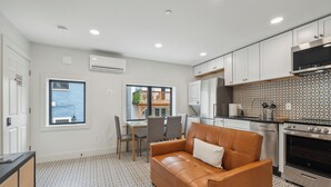 A modern kitchen with white cabinets, a built-in oven, and a patterned backsplash. - @StayatNoMA (Washington)