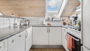 A modern kitchen with white cabinets, a Bosch dishwasher, a stove, and a skylight. - Cozy home in Harboøre (Harboøre)