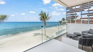Ein Balkon mit Blick auf Strand und Meer.
