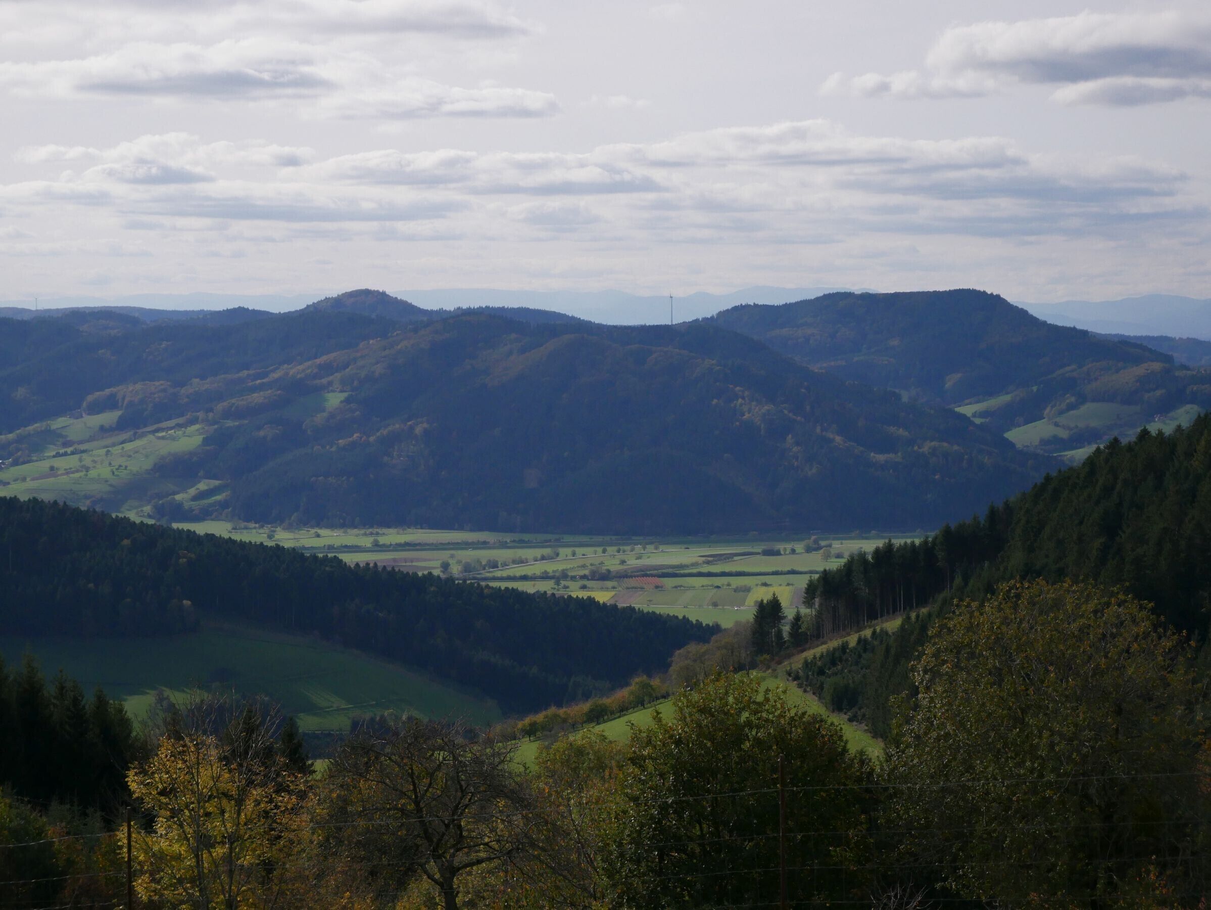 A mountainous landscape with rolling hills and a valley.