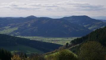 A mountainous landscape with rolling hills and a valley.