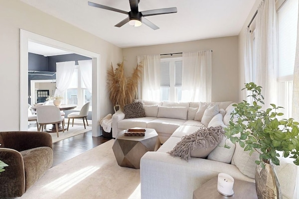 Living room is spacious with a large sectional. Large doorway, open floor plan