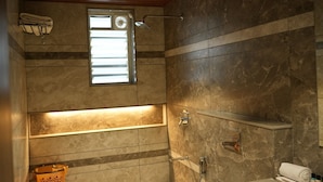 A bathroom with a shower, a window, and a towel rack. - Narayani Executive (Tuljapur)