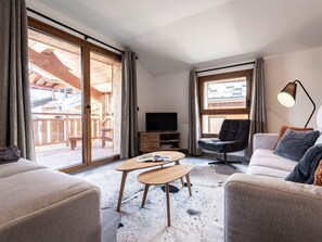 A modern living room with a sofa, armchair, and coffee table. - Luxurious 3BR Apartment for 8, 50m from Slopes & Lift in Montalbert, WiFi, Parking (La Plagne Montalbert)