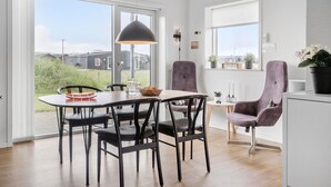 A modern dining area with a round table, four chairs, and a pendant light. - 3 bedroom lovely home in Ringkøbing (Ringkøbing)